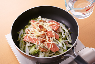 フライパンに豚肉を敷き、セロリ、ねぎ、鮭の順にのせる。梅干しをちぎって加え、しょうがを散らして水、ナンプラーを加え、ふたをして中火にかける。